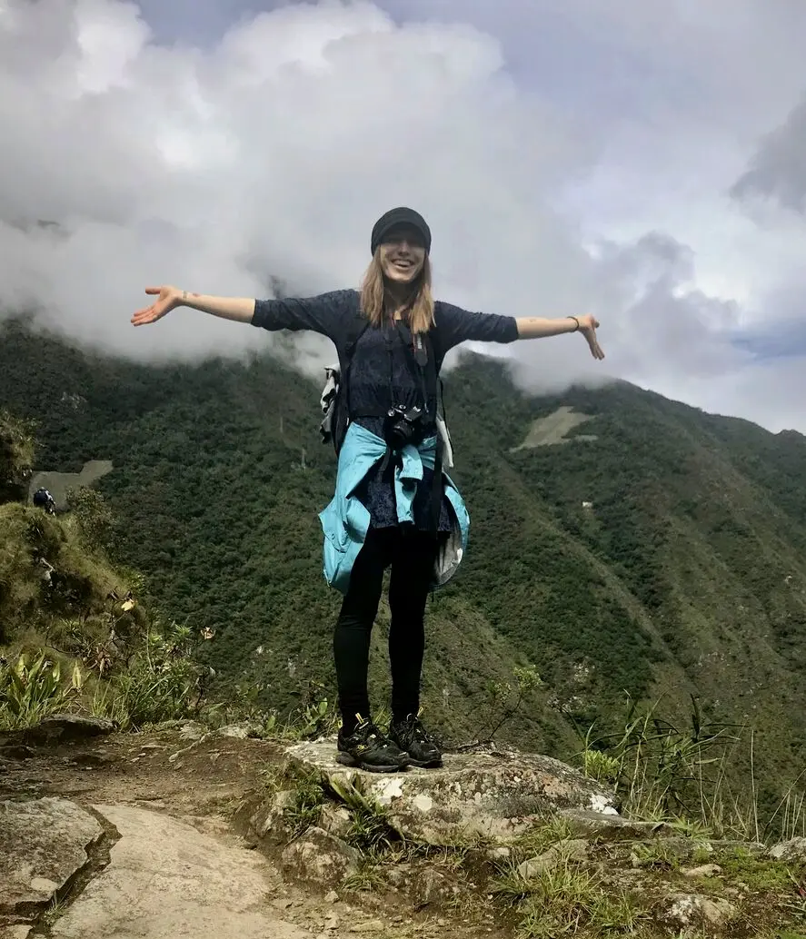 Filippa Rosenquist on a mountaintop, arms wide open