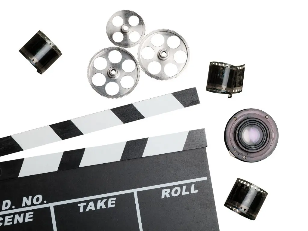 Film clapperboard and camera lens, representing video editing